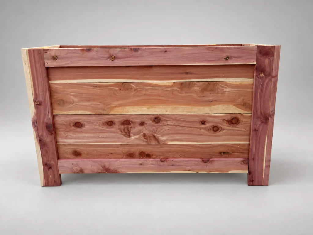 Front of the cedar planter with vertical corner posts and horizontal trim fitted.