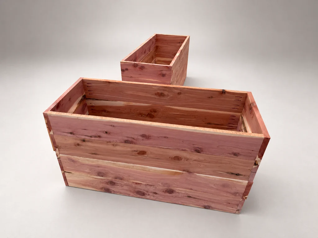 Elevated view of two cedar planter shells showing the front boards and interior corners.